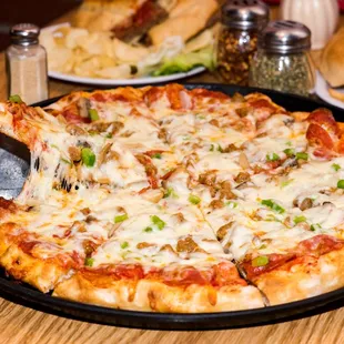 a pizza on a plate with a spatula