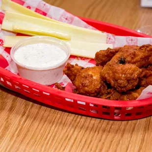 a basket of fried chicken and cheese