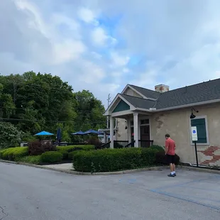 a man walking in front of a restaurant