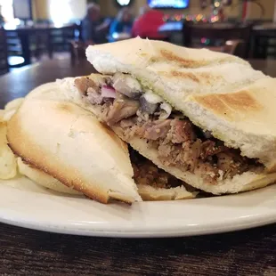 The fresh baked cheesesteak sub with potato chips.