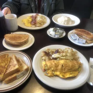 a breakfast of eggs, toast, bacon, and hash browns