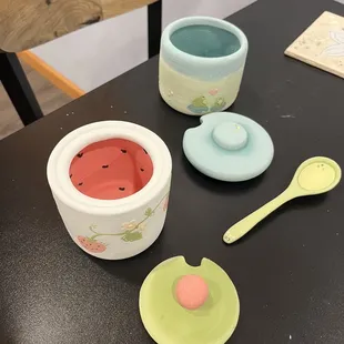 a bowl, spoon, and spoon rest on a table