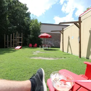 a person sitting on a red bench in a backyard