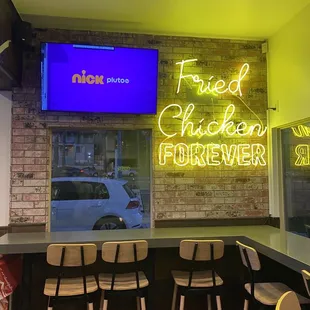 a neon sign that reads fried chicken forever
