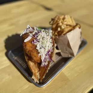 a sandwich and french fries on a tray