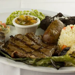 Our Churrasco Guatemalteco includes: 8 oz. Rib Eye Steak, Grilled Green Onion, Guacamole, Fried Black Beans, Rice, Longaniza and a Salad