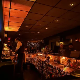 a bartender standing at the bar