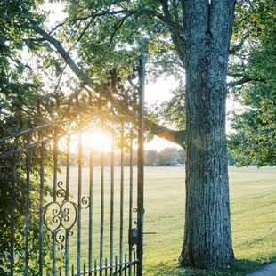 Front iron gate and sunset and Bryn Du Mansion