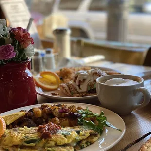 a plate of omelets and a cup of coffee