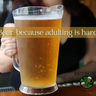 a woman holding a glass of beer