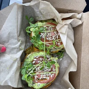 Avocado toast on a jalapeño cheddar bagel