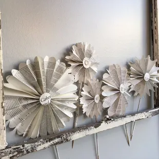 an old window decorated with paper flowers