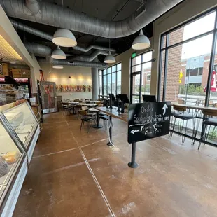 View of the dining room area and ordering station near the street entrance.