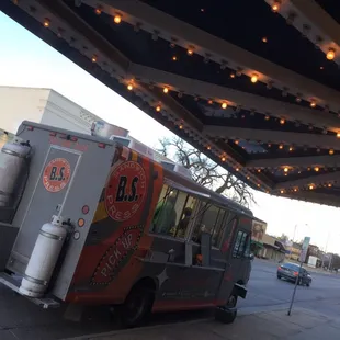 a food truck parked under a awning