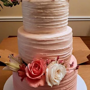 Beautiful textured pink ombre wedding cake. chocolate cake with chocolate ganache and caramel filling/Vanilla cake with fresh strawberry fil