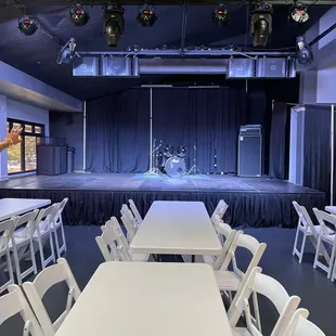 stage with white folding chairs