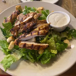 Grilled chicken Caesar salad and what&apos;s left of the fried pickles.