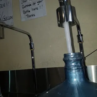 a blue bottle with a water faucet