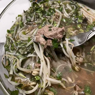 a bowl of soup with meat and vegetables