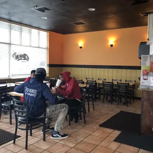 people sitting at tables in a restaurant