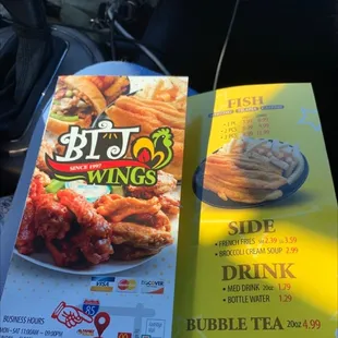 a menu and a drink on a table