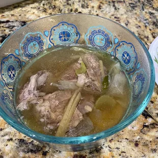 a bowl of soup on a granite countertop