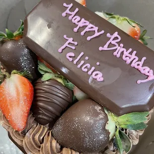 Chocolate vegan cake with strawberries. Half the berries dipped in chocolate, half naked.