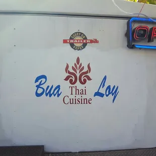 a sign on the side of a food truck