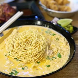 a bowl of noodles in a yellow sauce
