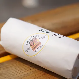 a hot dog wrapped in paper