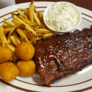 Half rack of ribs, coleslaw, hush puppies, and fries.