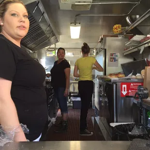 a woman standing in a kitchen