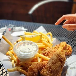 a basket of fried chicken and fries