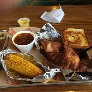 Half a chicken, baked beans, and fried, yes I said fried corn on the cob.