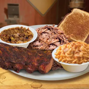a plate of ribs, macaroni and cheese