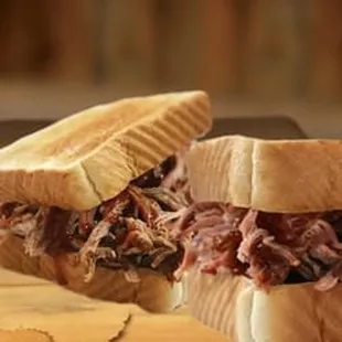 a pulled pork sandwich cut in half