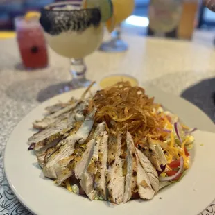 a plate of grilled chicken and salad