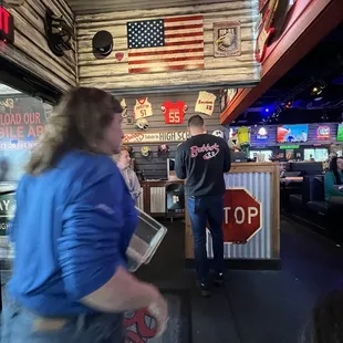 a man and a woman standing in front of a stop sign