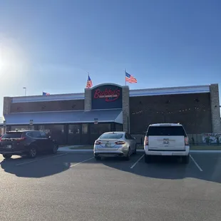 two cars parked in front of the restaurant