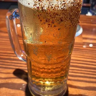 a glass of beer with a lime garnish