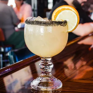 a margarita with a slice of orange