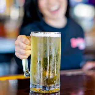 a woman holding a glass of beer