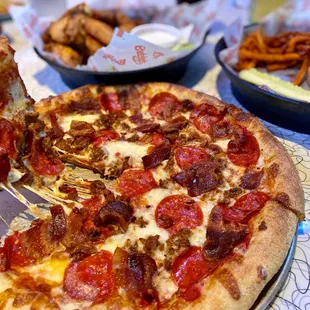 a pepperoni pizza with a slice taken out of it