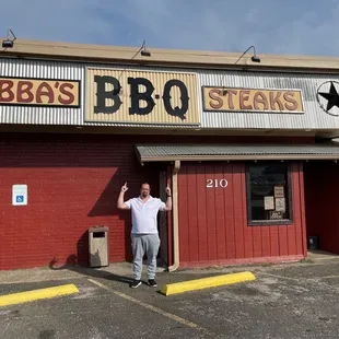 a man standing in front of a restaurant