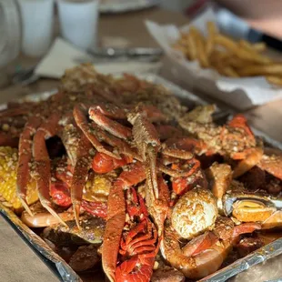 a tray of crab legs and corn on the cob