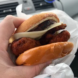 a hand holding a sandwich