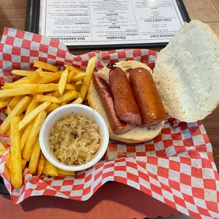 Savory hot kielbasa on a fresh chewy roll, with hot crispy-edged fries and a side of sauerkraut.
