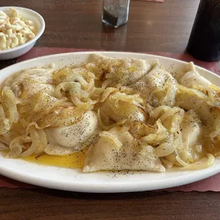 Pierogies, deliciously sautéed and butter with sweet onions!