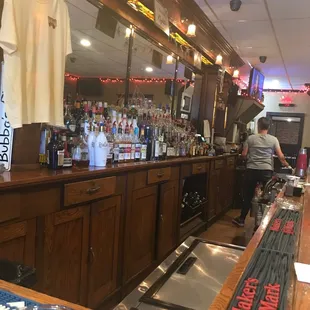 a bar with a man at the counter