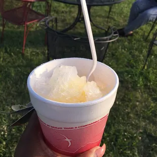 a hand holding a cup of shaved ice